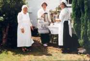 Serving teas in traditional costume in front of the Village Shop, Centenary Celebrations, 1994