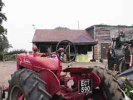 A Farmall tractor, facing the cafe and shop