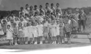 School-children, many wearing sashes