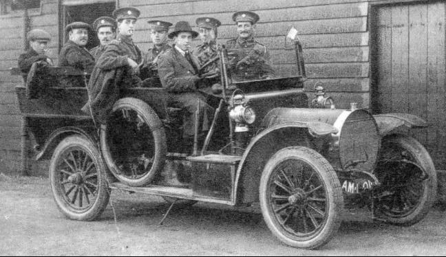 The Taxi  from  Bentley's Garage taking staff for an evening in Wokingham; the building in the background is the Quartermasters Stores 